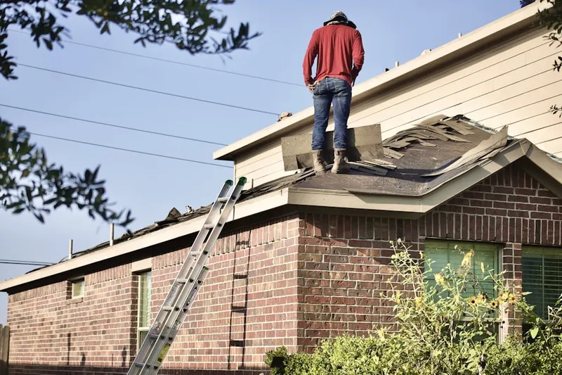 Professional roofer working on a residential roof in Berkley